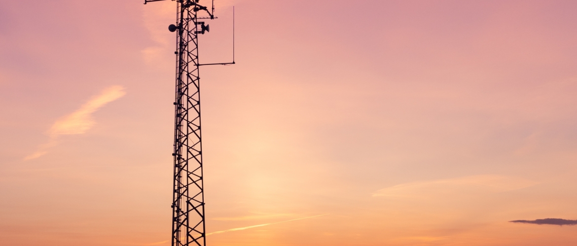 Vertical shot of a telecom tower in a field under the breathtaking sky -perfect for wallpaper A vertical shot of a telecom tower in a field under the breathtaking sky -perfect for wallpaper