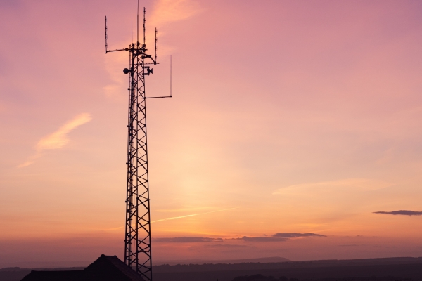 Vertical shot of a telecom tower in a field under the breathtaking sky -perfect for wallpaper A vertical shot of a telecom tower in a field under the breathtaking sky -perfect for wallpaper
